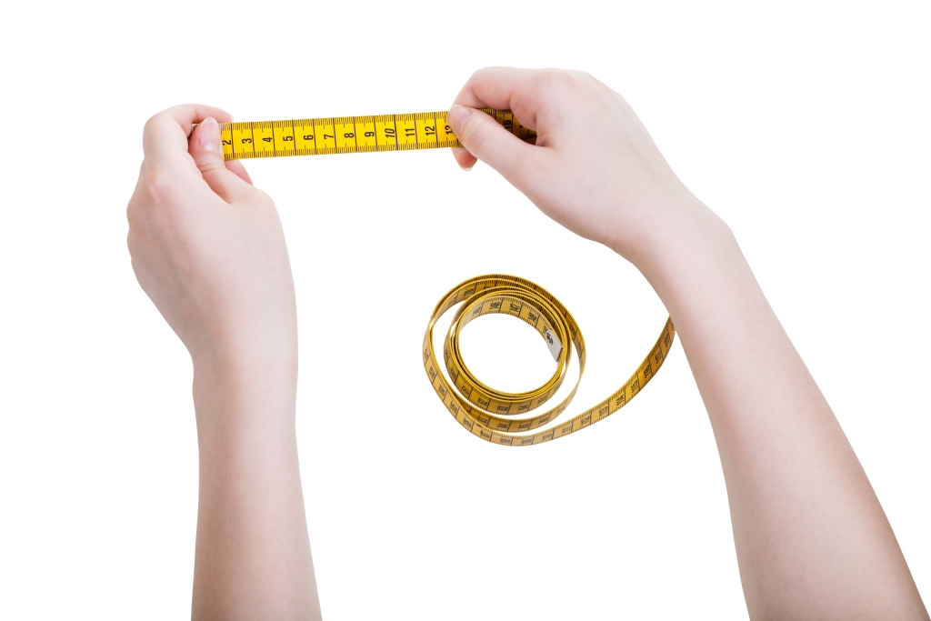 Female hands with tailor measuring tape isolated